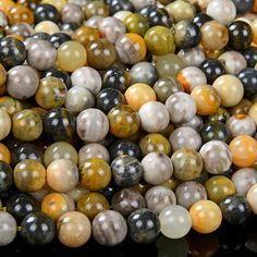 multicolored marble beads are stacked on top of each other in this close up photo