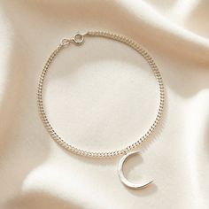 A gorgeous Crescent Moon Charm Bracelet for those drawn to the mystique and romance of the moon. This beautiful Crescent Moon Charm Bracelet features an elegantly smooth curved moon pendant, reminiscent of the moon's gentle arc visible in the night sky. Made from Sterling Silver and plated by our jewellers in a warm 18ct gold, adding a touch of celestial beauty to the piece. This gorgeous bracelet is a versatile accessory that adds a touch of celestial charm to both casual and more formal outfits. Carry a bit of the moon's magic and allure with you! 925 Sterling Silver Posh Totty, Forever Jewelry, Formal Outfits, Creating Jewelry, Jewelry Ring Box, Moon Charm, Men's Jewelry Rings, Gifts For Brother, Gorgeous Bracelet