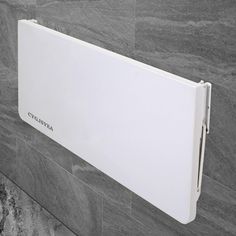 a white radiator mounted to the side of a wall