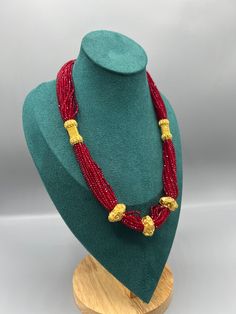 Introducing the exquisite "Nepalese Katar Gedi Hydro Potey Necklace" - a masterpiece inspired by the rich cultural heritage of Nepal. Handcrafted with love and skill by talented artisans, this necklace embodies the essence of Nepalese craftsmanship. Our company offers expedited Next-Day Delivery Services within the United Kingdom, ensuring prompt and efficient transportation of goods.  Additionally, we strive to extend our shipping capabilities to cater to customers worldwide, aiming to provide Nepali Jewelry Gold, Red Beads Necklace, Green Beads Necklace, Nepalese Jewelry, Nepali Jewelry, Red Beaded Necklaces, Red Beads, Green Beads, Dress Jewelry