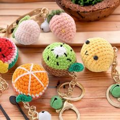 crocheted fruit keychains are sitting on a table