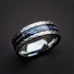 a wedding ring with blue and black stripes