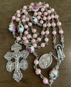 "This beautiful handmade rosary is made with 6mm pink  glass beads, 8mm ceramic beads and 2\"  crucifix.   Length: 20\" inches long" Adjustable Pink Rosary Bracelet With 8mm Beads, Handmade Pink Rosary Bracelet With Round Beads, Handmade Pink Rosary For First Communion, Pink Spiritual Rosary Bracelet With 8mm Beads, Pink 8mm Bead Spiritual Rosary Bracelet, Pink Beaded Spiritual Rosary Bracelet, Pink 8mm Beads Rosary Bracelet, Mother's Day Rosary With 8mm Beads, Pink Spiritual Jewelry With 8mm Beads