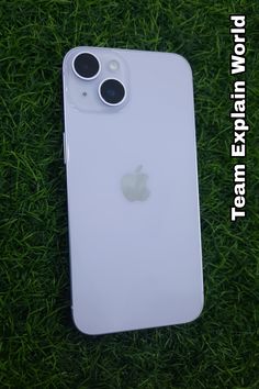 an iphone is laying in the grass with its camera lens on it's back