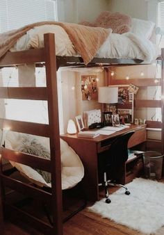 a bunk bed with a desk underneath it in a room that has wood floors and white walls