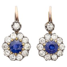 Exceptional stones meet classic design in these beautiful sapphire and diamond drop earrings. Made of 18 karat gold, at the center of each of these gorgeous earrings is a fine round vibrant blue sapphire weighing 0.80 carats (1.60cttw) surrounded by a halo of fine white natural old cut diamonds and a single diamond suspended above each halo, for a total diamond weight of 1.65 carats. The earrings hang just under 1.0" long and weigh 4.1 grams total, while the old cut diamonds average G-H color and VS2-SI1 clarity, delivering more than enough sparkle! Treat yourself or someone you love to some ear candy! Gold Flapper, Blink Blink, Yellow Gold Drop Earrings, Vintage Drop Earrings, Sapphire And Diamond Earrings, White Gold Sapphire, Diamond Dangle Earrings, Ear Candy, Long Dangle Earrings