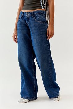 Motel jean in an extra wide-leg silhouette bring the ‘90s vibes. Designed in a classic rigid denim with a slouchy low-rise and roomy fit to be your new wear-with-everything favorites. Features Motel Roomy extra wide low rise jean Low rise baggy jean Rigid non-stretch denim Low rise waist that sits at the hips Roomy fit 5-pocket styling Zip fly and button closure Content + Care 100% Cotton Machine wash Imported Size + Fit Low rise Roomy extra wide leg Full length Model in Indigo is 5’8" and wearing size 28 Measurements taken from size 28 Waist: 31" Rise: 9" Inseam: 30.5" Length: 39" | Motel Roomy Extra Wide Low Rise Jean in Indigo, Women's at Urban Outfitters Low Rise Baggy Jeans, Low Rise Jean, Baggy Jean, 80s Outfit, Casual Tanks, 90s Vibes, School Dresses, Low Rise Jeans, Light Wash Jeans