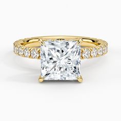 a princess cut diamond ring set in yellow gold