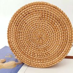 a wicker purse sitting on top of a book