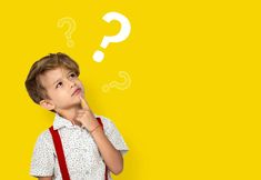 a young boy standing in front of a yellow background with question marks above his head