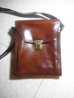 Vintage brown leather satchel bag, clasp closure, shoulder strap (total length 42in), inside zippered pocket, outside pocket under clasp, Dimensions Height 10in, width 8in, depth 2.5in,  wear on inside flap of bag (shown in last pic) back of bag slightly scratched.as shown in pics.  Good condition, sold as is. The wear on the bag actually gives it character. Flap Shoulder Bag With Hasp Closure For Business, Business Flap Shoulder Bag With Hasp Closure, Business Shoulder Bag With Flap Hasp Closure, Business Shoulder Bag With Flap And Hasp Closure, Brown Flap Satchel With Hasp Closure, Retro Satchel With Adjustable Strap For Formal Use, Retro Formal Satchel With Adjustable Strap, Retro Satchel With Adjustable Strap For Formal Occasions, Brown Satchel Briefcase With Hasp Closure