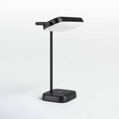 a desk lamp with a black base and a white light on it's side