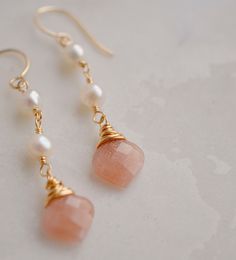 Add a subtle touch of elegance to your look with these beautiful Peach Moonstone and Freshwater Pearl dangle earrings. With their warm, peachy tones and soft pearls, these earrings feel inviting and calming and are perfect for weddings or special occasions.Peach Moonstone is known for aiding in the release of negative thinking and being overly self-critical. It's believed to be a stone of new beginnings, that brings balance and relief from emotional issues. The matching necklace is here.LENGTH: Elegant Apricot Dangle Earrings, Elegant Peach Pearl Jewelry, Elegant Apricot Earrings For Gift, Elegant Apricot Dangle Jewelry, Elegant Handmade Blush Jewelry, Peach Pearl Drop Jewelry As Gift, Peach Pearl Drop Jewelry Gift, Peach Pearl Drop Jewelry For Gift, Elegant Peach Dangle Earrings