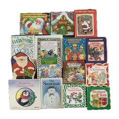 many children's books are stacked on top of each other, with santa claus in the background