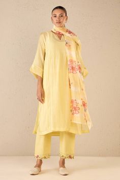 Yellow three fourth sleeves kurta with pintucked yoke detail. Paired with a floral border embroidered pant and floral printed dupatta. - Aza Fashions Spring Chanderi Palazzo Set With Straight Kurta, Spring Cotton Silk Kurta With Printed Motifs, Cotton Silk Straight Kurta Set For Spring, Spring Anarkali Set With Straight Kurta And Dupatta, Elegant Anarkali Set With Embroidered Border For Spring, Elegant Spring Anarkali Set With Embroidered Border, Spring Chanderi Salwar Kameez With Printed Motifs, Chanderi Salwar Kameez With Printed Motifs For Spring, Spring Chanderi Salwar Kameez With Embroidered Border