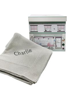 a blanket with the name charlie on it next to a box that says charlie