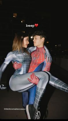 two people dressed as spider man and woman