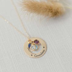 A beautiful golden gift for your Grandma or Mom. What better way to remind her of her family - a necklace personalized with names and birthstones representing each grandchild Product details MATERIAL: 14K Gold Pendant, Plated or Gold Filled ChainSIZE: 1 1/8" (28.575) pendantCHAIN LENGHT: 16", 18", 20" based on selectionCHAIN STYLE: cable, curb, rolo, double ropeBIRTHSTONES: Optional based on selectionENGRAVING: Up to 5 characters (including spaces) around the circumference of the washer Engraved Mother's Day Yellow Gold Birthstone Necklace For Mom, Yellow Gold Birthstone Necklace For Mother's Day, Customizable Gold Birthstone Necklace Gift For Mom, Personalized Round Gold Birthstone Necklace, Personalized 14k Gold Birthstone Jewelry, Keepsake Yellow Gold Jewelry With Birthstone, Sterling Silver Name Necklace With Birthstone In Yellow Gold, Gold Birthstone Necklace With Name On Round Pendant, Yellow Gold Birthstone Jewelry For Keepsake