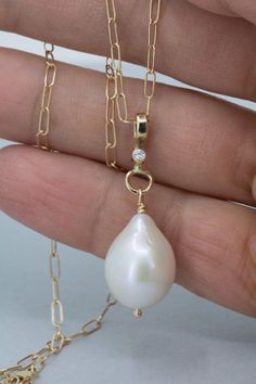 "Large white teardrop shape freshwater pearl pendant in solid gold. This classic and timeless piece has a beautiful and luminous AA quality natural freshwater pearl with a very smooth surface/blemish free and higher luster. The pearl has a slight teardrop baroque shape and dangles from a 14K solid gold handmade pendant with a diamond also set in 14K gold. The pendant is shown with two different chains a rope chain and a cable chain. Both are solid 14K gold and are sold separately. You can also u Yellow Gold Drop Jewelry With Single Diamond, Yellow Gold Jewelry With Pearl Pendant Dangle, Drop Jewelry With Single Diamond For Anniversary, Drop-shaped Single Diamond Jewelry For Anniversary, Drop Shaped Single Diamond Jewelry For Anniversary, Drop Shape Single Diamond Jewelry For Anniversary, Yellow Gold Diamond Jewelry With Pearl Drop, 14k Gold Pearl Drop Pendant Jewelry, Diamond Drop Jewelry With Pearl Pendant