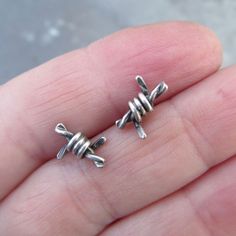 "Small Barbed Wire Stud Earrings Sterling Silver Men Women Grunge Punk Goth Unisex Stud Earrings : Little barbed wire bits handmade out of sterling silver. 100% handmade by me. They measure about 1/2\". Great for a special guy or gal! 100% handmade by me in my little home studio. Enter my shop: https://www.etsy.com/shop/artdi Join me on Facebook: https://www.facebook.com/Artdi-Diana-Anton-Jewelry-Design-44805607932/ Find me on Instagram: https://www.instagram.com/dianaantonjewelrydesign/" Silver Earrings For Men, Nickel Free Edgy Plug Earrings As Gift, Edgy Nickel-free Plug Earrings As Gift, Punk Style Metal Cartilage Earrings, Handmade Edgy Plug Earrings As Gift, Handmade Edgy Plug Earrings For Gift, Edgy Nickel-free Earrings For Gift, Handmade Punk Cartilage Earrings, Handmade Punk Cartilage Earrings For Gifts