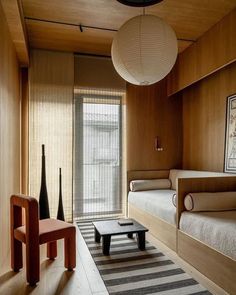 a room with wooden walls and two beds