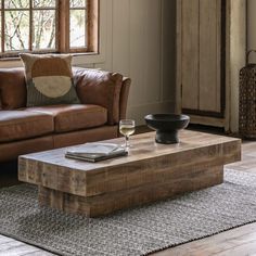 a living room with a couch, coffee table and window