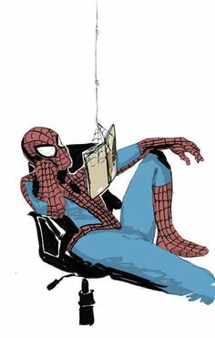 a spider man sitting on top of a chair next to a computer monitor and holding a book