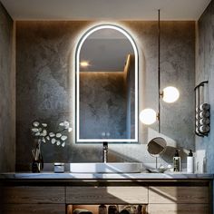 a bathroom with a sink, mirror and lights on the wall above it's counter