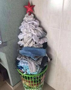 a pile of clothes sitting in a laundry basket next to a shower stall with a red star on the top