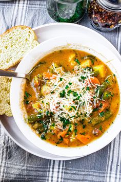 a bowl of soup with bread and parmesan cheese