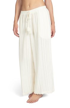 Lounge poolside in these textured wide-leg pants designed with a tassel-tie waist and lacy trim. Ties at waist Unlined 100% cotton Hand wash, dry flat Imported Wide Leg Bottoms With Tassels, Chic Tassel Pants For Spring, Elegant Beach Bottoms With Tie Waist, Elegant Cream Bottoms For Beach, Elegant Cream Beach Bottoms, Chic Beach Bottoms With Tassels, Spring Wide Leg Pants With Tassels, White Bottoms With Tassels For Spring, White Tie-side Bottom Pants For Spring