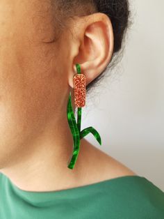 Bulrush Earrings Elegant bulrush earrings made with laser cut marble green leaves and glistening copper seed heads. Materials: Front - Acrylic Gold plated stud backs **Care** Please store and transport your jewellery in a box.  Keep away from water, perfume and other sprays and lotions as this can discolour metal parts. Green Leaf-shaped Party Jewelry, Laser Cut Jewelry Acrylic, Seed Heads, Red Gift Box, Water Perfume, Laser Cut Jewelry, Red Gift, Earrings Elegant, Acrylic Jewellery