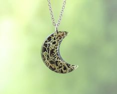 Capture the magic of the moon and the beauty of the forest with this enchanting moon pendant necklace, featuring real lichen 🍃 preserved in a stunning crescent moon 🌙 shape. This forest-inspired necklace is perfect for nature lovers and those drawn to the mystical beauty of the night sky. This unique moon jewelry makes a meaningful gift for him or her 🎁, whether it's for a birthday, holiday, or just because. The combination of natural elements and celestial design makes this necklace the perfect way to carry a piece of both the earth and sky wherever you go. 🍄 Our Botanical Jewelry: https://www.etsy.com/es/shop/NatureResinJewelry?section_id=51200953 💚 Handmade with love and care 💚 ADDITIONAL INFORMATION 🎁 This unique nature necklace comes carefully packaged in a gift box, making it Handmade Moon Shaped Nature-inspired Necklace, Nature-inspired Moon Charm Pendant Necklace, Nature-inspired Necklace With Moon Charm Round Pendant, Nature-inspired Necklace With Round Moon Charm Pendant, Nature-inspired Round Pendant Necklace With Moon Charm, Nature-inspired Moon Charm Jewelry As A Gift, Nature-inspired Round Pendant Jewelry With Moon Charm, Nature-inspired Moon Charm Necklace As A Gift, Nature-inspired Moon Charm Necklace As Gift