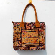 This bohemian banjara bag is the perfect accessory for the bohemian fashionistas. Key Features: Hand made in India. Fair trade guaranteed. Zipper top. Inside zipper pocket. Size ( Approx ) Height - 12 Inches/30 Cm. Width - 15 Inches/38 Cm. Handle Length 10 inches/ 25 Cm.  Inside Pocket - 3 ( As you can see in the picture ) Zipper Pocket - 1 Made from vintage Banjara  mirror work embroidery, it's a strong bag, and the perfect size for all your essential everyday stuff and more.... You'll get a lo Rectangular Hobo Bag For Everyday Use And Festivals, Travel Tassel Shoulder Tote Bag, Travel Tote Shoulder Bag With Tassels, Bohemian Brown Satchel With Double Handle, Brown Bohemian Satchel With Double Handle, Daily Use Shoulder Bag With Tassels And Double Handle, Daily Use Double Handle Shoulder Bag With Tassels, Daily Double Handle Shoulder Bag With Tassels, Daily Use Double Handle Tassel Shoulder Bag