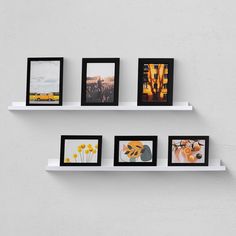 three white shelves with four different pictures on them