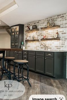 an image of a kitchen with brick walls and wood flooring on the wall, along with bar stools