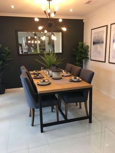 a dining room table set with place settings