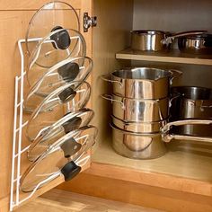 pots and pans are stored in the cabinet