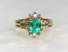 Emerald Ring, Vintage Emerald Engagement Ring, Emerald diamond Ring, Gemstone Engagement Ring, Vintage Jewelry, Emerald Ring 14k, 14k ring A classy vintage emerald ring featuring an oval cut center stone weighing 0.81 carats set amidst 10 sparkling colorless diamonds weighing 0.20 carats set in solid 14k yellow gold. *Ring size: US 7 1/2 *Ring weight: 6.39 Grams *Center stone dimensions: 6.7X5.2mm Vintage Emerald Ring With Diamond Accents, Vintage Diamond Cluster Ring With Accent Stones, Vintage Diamond Ring With Accent Stones For Anniversary, Heirloom Emerald Ring With Diamond Accents For Anniversary, Vintage Emerald Ring With Accent Stones For Anniversary, Vintage Diamond Rings With Accent Stones, Vintage Emerald Engagement Ring, Engagement Ring Emerald, Jewelry Emerald