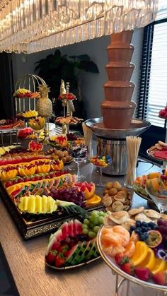 a buffet table filled with lots of different types of foods and desserts on it