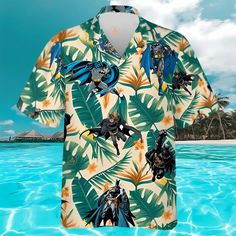 Batman Green Tropical Hawaiian Shirts The Hawaiian Shirt is an iconic symbol of laid-back, tropical style. Crafted from lightweight, breathable fabrics, it offers a comfortable and relaxed fit, perfect for warm weather escapades. Its vibrant, exotic patterns evoke the spirit of the Hawaiian islands, radiating a sense of fun and adventure. With its button-up design and collared finish, it strikes the perfect balance between casual and smart-casual attire. Whether you’re strolling along the beach Summer Beach Shirt In Patterned Design, Multicolor Graphic Print Beach Shirt, Hawaiian Printed Relaxed Fit Shirt, Multicolor Tops For Surfing, Beach Season, Multicolor Graphic Print Beachwear Top, Multicolor Graphic Print Shirt For Vacation, Multicolor Tops For Surfing Beach Season, Summer Patterned Shirt With All Over Print, Summer Patterned Shirt With Graphic Print