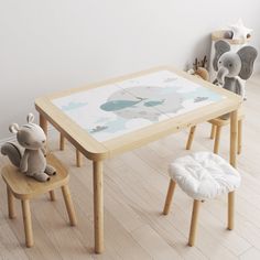 a wooden table with two chairs and an elephant figurine on the floor next to it