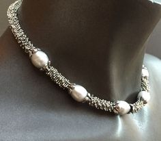 The necklace is 16.5 inches long. It is a classic combination of big white rice pearls and sterling silver beads. It sits comfortably on your neck and would be appropriate for a wedding, dinner out, or the office! It would be a perfect bridesmaid gift or birthday present for a June birthday. Great christmas present for someone special, too. Elegant Polished Pearl Necklace For Anniversary, Elegant Oval Beaded Necklaces, Elegant Silver Pearl Necklace With Sterling Silver Clasp, Elegant Oval Beaded Necklace, Classic Silver Beaded Necklaces With Pearl Pendant, Silver Classic Beaded Necklace With Pearl Pendant, Silver Oval Beads Jewelry For Formal Occasions, Classic Silver Beaded Necklace With Pearl Chain, Elegant Necklace With Silver Oval Beads