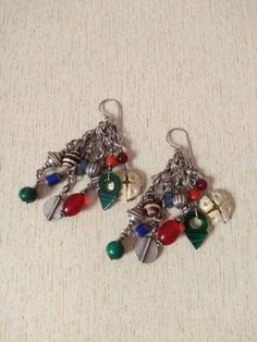 This is a beautiful silver berber earrings from Morocco with Talhakimt, Old Coral bead, small silver berber pendant, stones, and shell. These earrings have a good size and weight to be worn. Length : 8,3 cm (3,2 inches) Diameter of items : 0,4 cm to 1,2 cm (0,1 inches to 0,4 inches) Weight : 35,2 g Festival Dangle Earrings With Silver Beads, Silver Vintage Beaded Earrings With Dangling Beads, Dangle Earrings With Silver Beads For Festivals, Silver Beaded Dangle Earrings For Festivals, Silver Beaded Drop Earrings With Natural Stones, Artisan Silver Earrings With Round Beads, Festival Sterling Silver Earrings With Dangling Beads, Sterling Silver Dangling Beads Earrings For Festival, Silver Dangle Beaded Earrings With Natural Stones