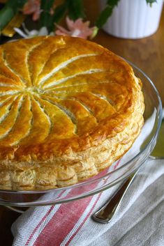 a pie sitting on top of a glass cake plate