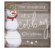 a wooden sign that says i'm dreaming of a cowboy christmas with a snowman