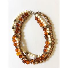 Gorgeous Vintage 1960s Three-Row Amber, Wooden and Ivory Beaded Necklace with silver accents. Choker length, sits beautifully against the neck. In excellent condition!! Vintage Multi-strand Beaded Necklace With Polished Beads, Vintage Necklaces With Wooden Beads, Vintage Handmade Double Strand Beaded Necklace, Vintage Multi-strand Beaded Necklace, Vintage Multi-strand Beaded Necklaces, Vintage Adjustable Beige Necklace, Adjustable Vintage Beige Necklace, Vintage Beige Adjustable Necklace, Vintage Cream Single Strand Necklaces