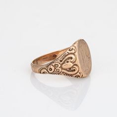 Lovely antique Victorian signet ring (circa 1880s to 1900s), crafted in 10 karat rose gold.   From what we can decipher, the center mount is engraved with the initials "PML"   The side shoulders feature a pretty scrolling design that terminates to the oval mount. The saddle of the ring is low and curves to the shape of the finger, rising 1.5mm from the finger (0.05 inches).     The ring is in good condition with patina and wear evident. We have not cleaned the ring in order to preserve the patina and collector value.    Particulars:  Weight: 5.8 grams  Stones:  N/A.  Size & Measurements: The ring is a size 11 (sizable). The mount measures 16mm in length (0.62 inches) and 12.5mm wide (0.49 inches), rising 1.5mm from the finger.   Metal & Hallmark: 10 karat rose gold. The ring is not hallmar Rose Gold Heirloom Signet Ring, Victorian Signet Ring With Intricate Design, Victorian Style Signet Ring With Intricate Design, Hallmarked Oval Initial Ring In Rose Gold, Classic Gold Engraved Memorial Ring, Classic Gold Engraved Ring For Memorial, Victorian Engraved Rings For Memorial, Gold Classic Engraved Ring For Memorial, Antique Engraved Ring For Memorial