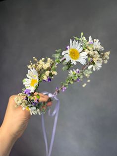 a person holding flowers in their hand