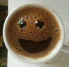 a coffee cup with a smiley face drawn on it